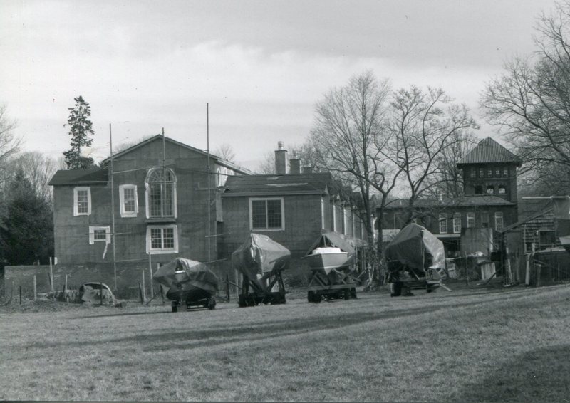 covered boats in front of new building.jpg